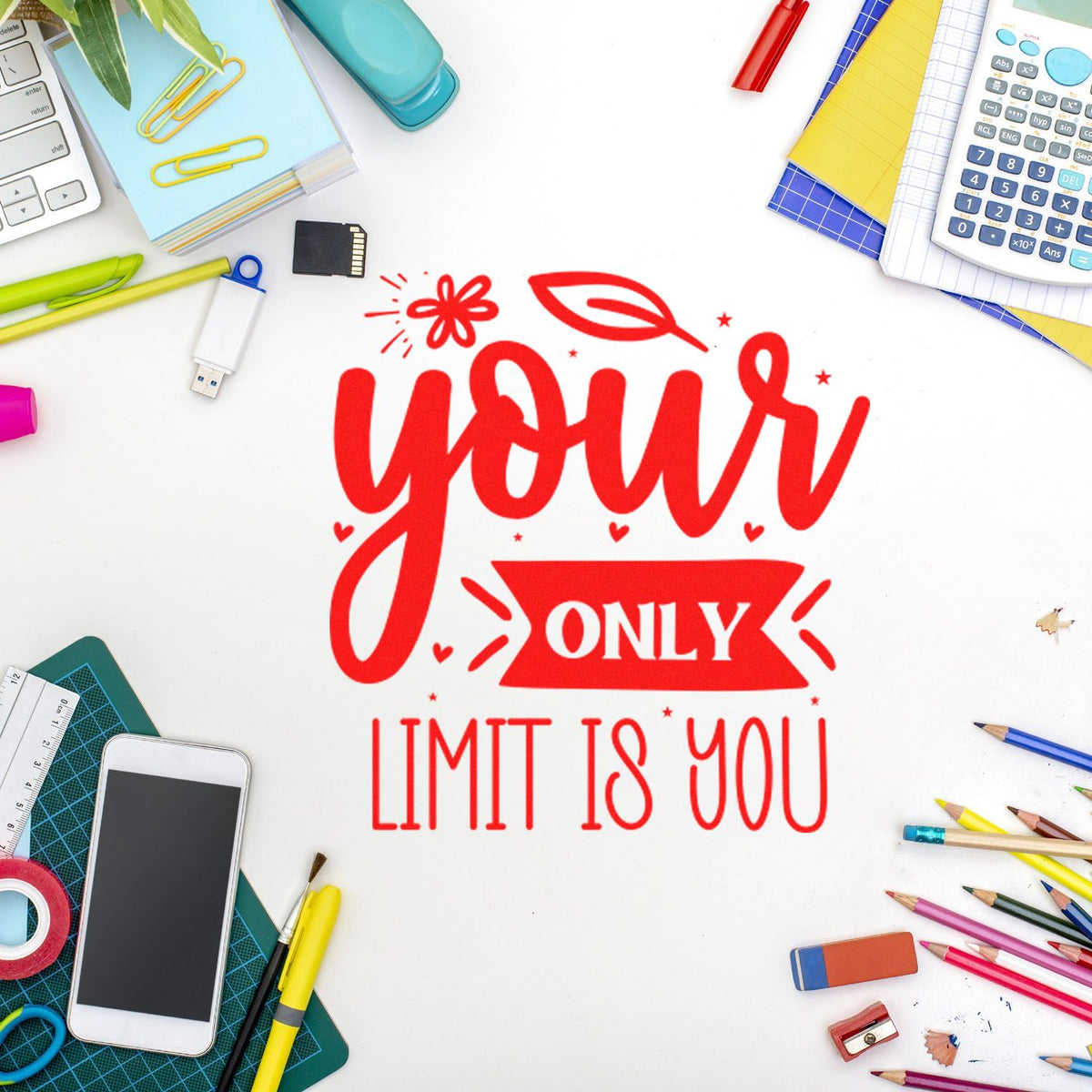 Red motivational rubber stamp reading Your Only Limit Is You on a creative desk with stationery and office supplies.