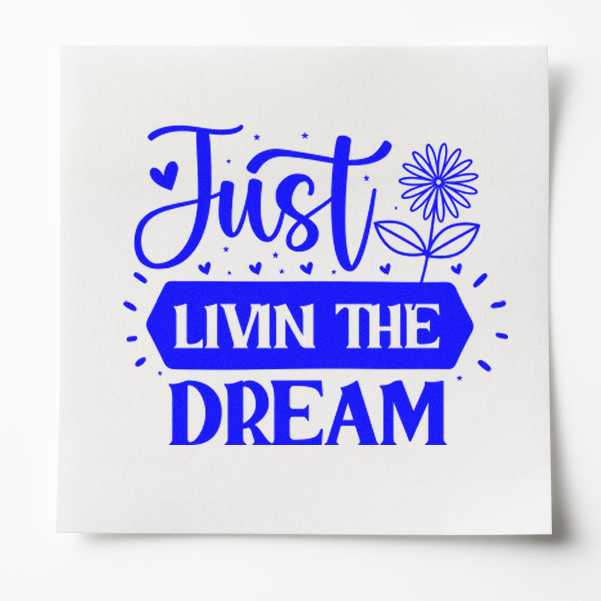 Blue Just Livin the Dream rubber stamp design with flower and heart accents on white paper.