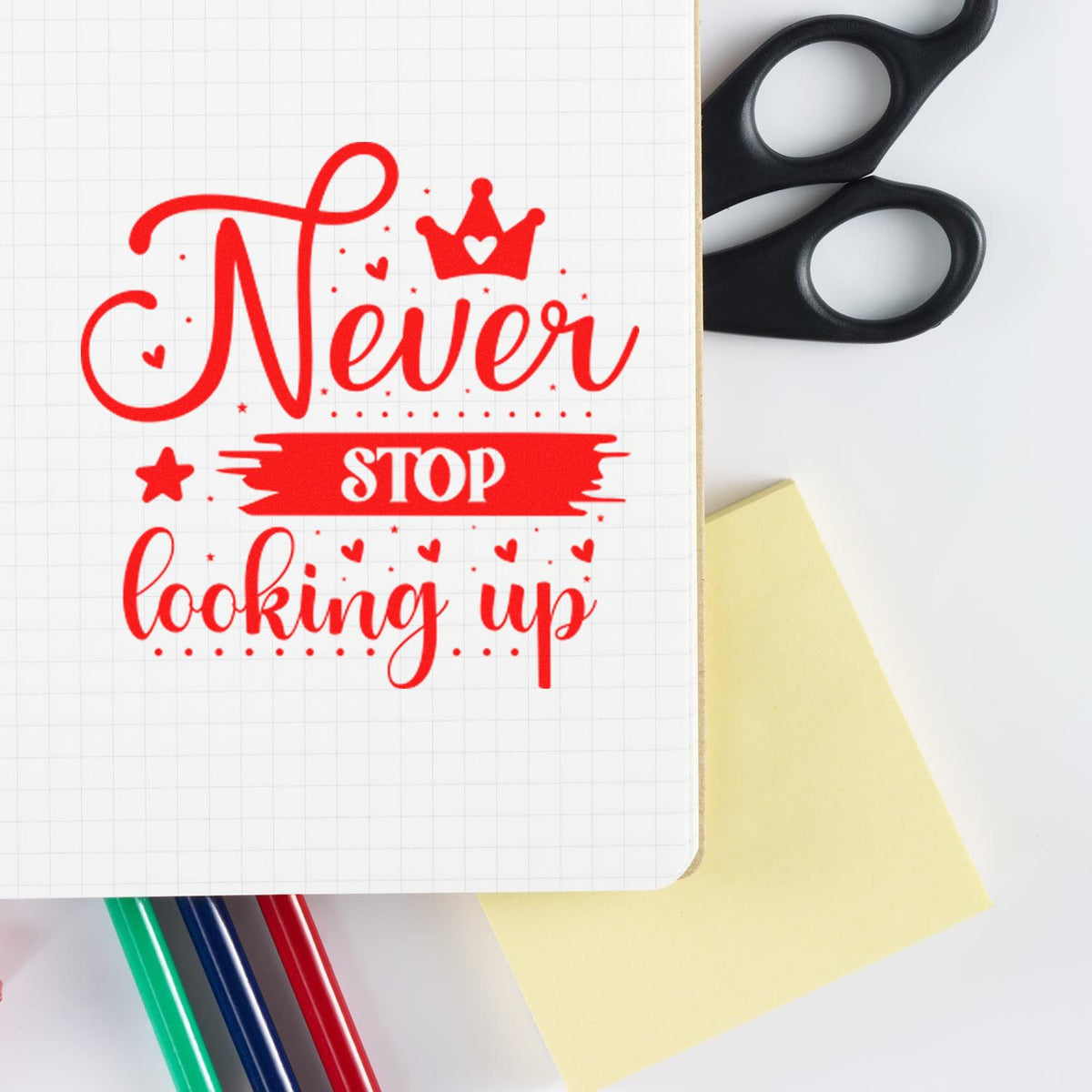 Inspirational rubber stamp design with Never stop looking up in red for notebooks, journals, and stationery.