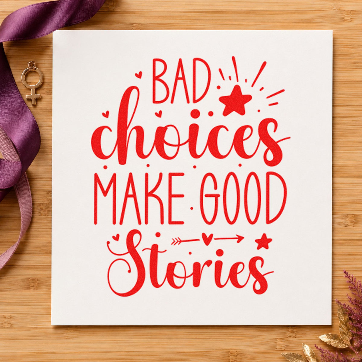 Bad Choices Make Good Stories craft stamp imprint in red ink on a handmade project, one idea being story note cards.