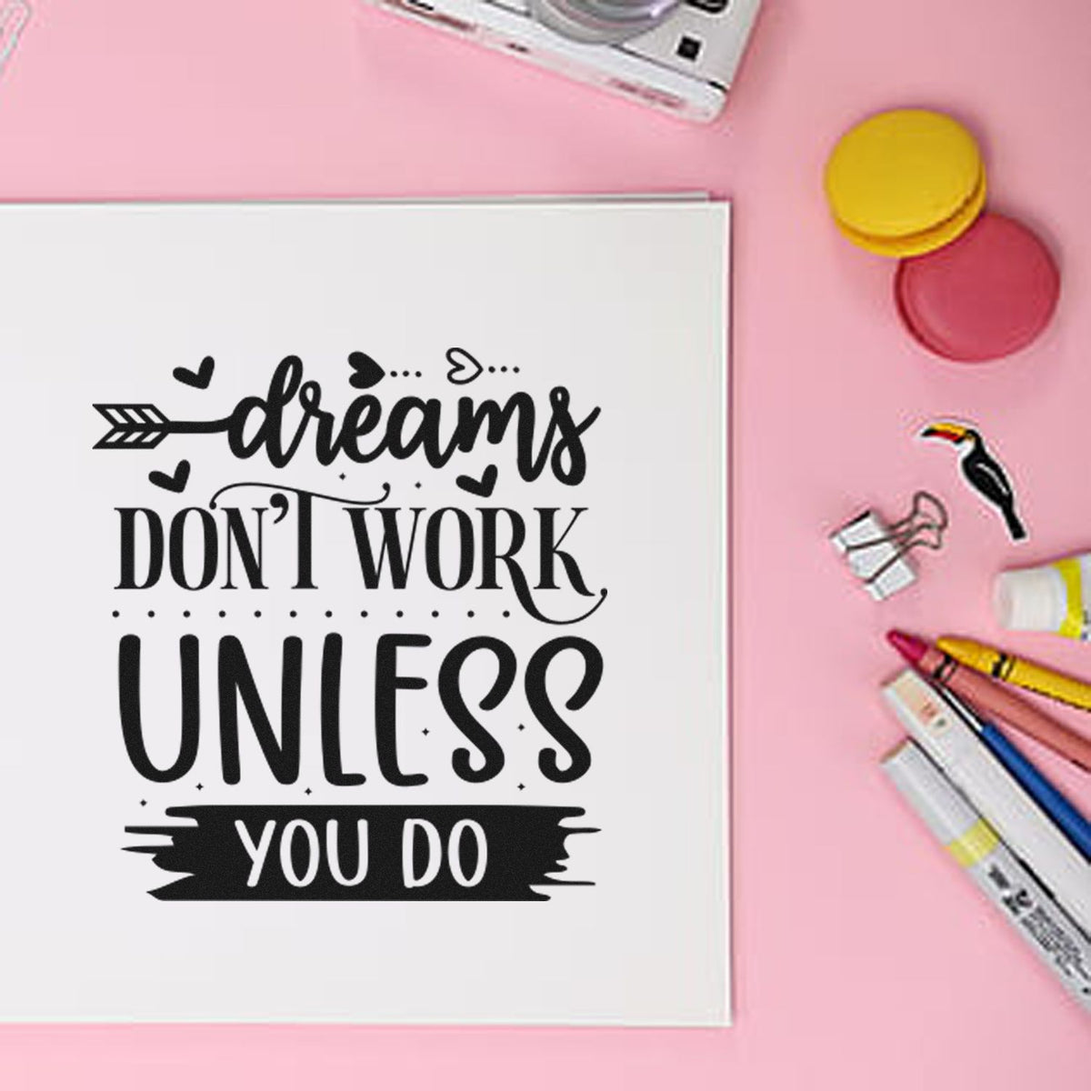Inspirational rubber stamp design with quote Dreams dont work unless you do on notebook, styled with ink pads and markers.