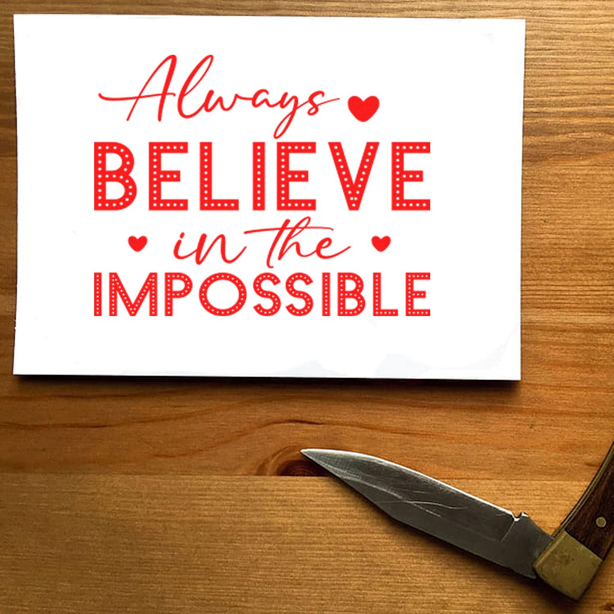 Inspirational rubber stamp with quote Always believe in the impossible in red, perfect for handmade cards and craft projects.