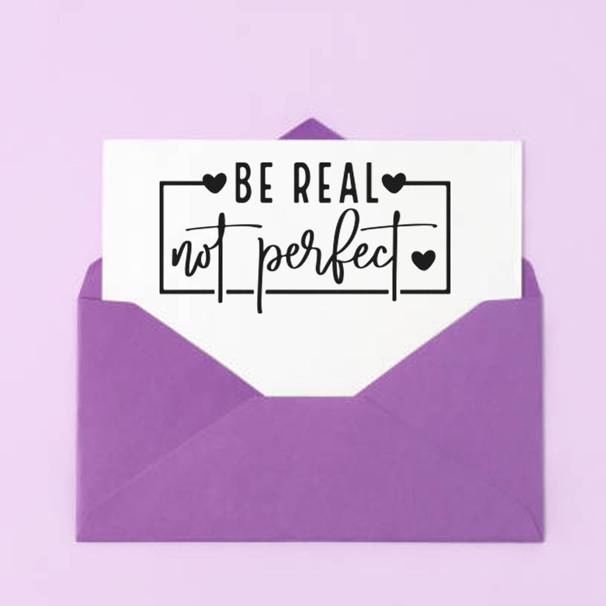 Rubber stamp design reading Be real not perfect with hearts, ideal for cards, envelopes, and handmade stationery.