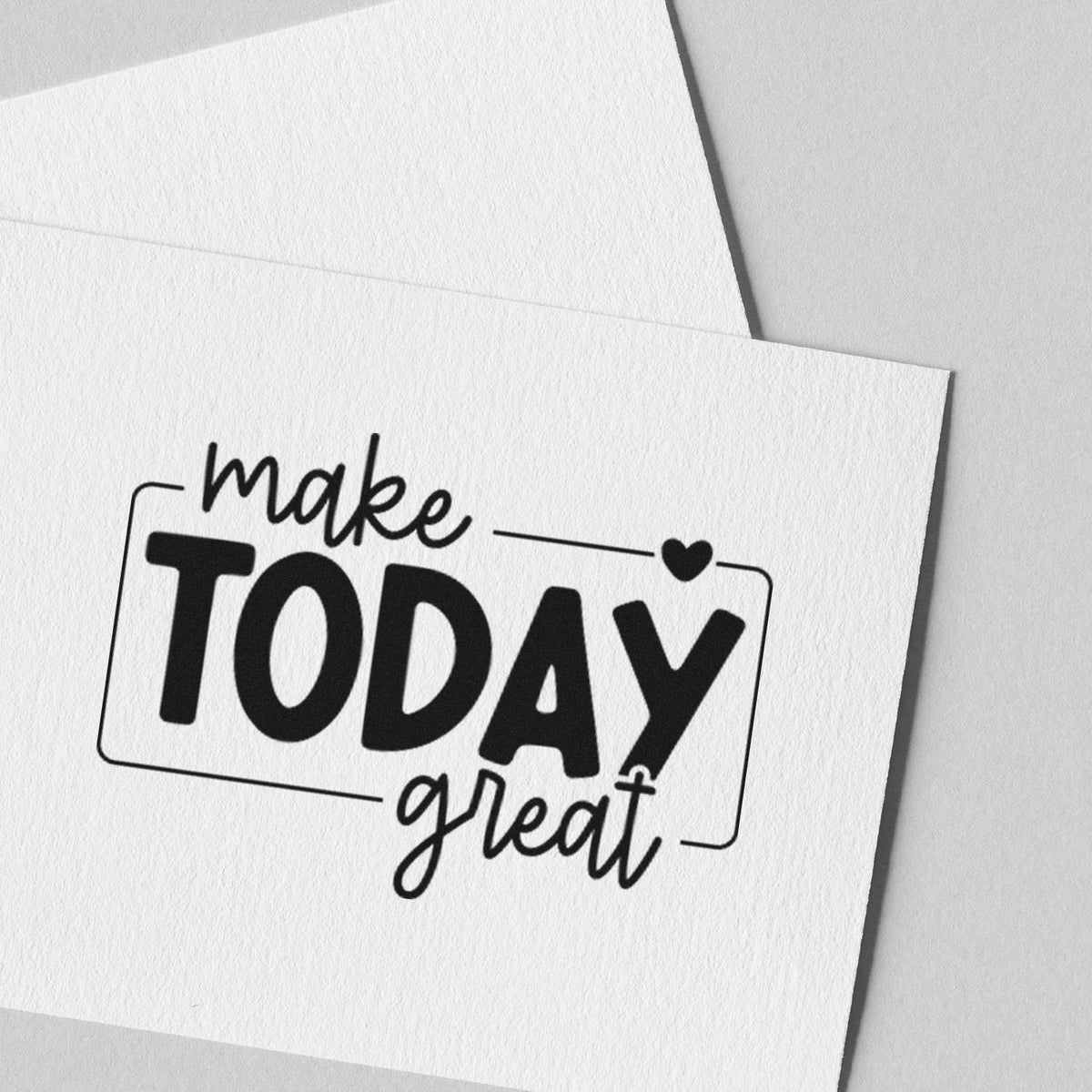 Custom rubber stamp design with motivational quote make TODAY great and heart, stamped on white paper.