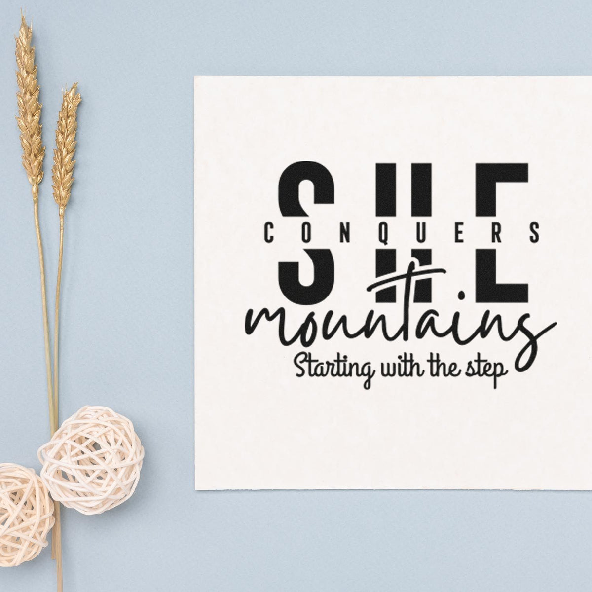 Custom rubber stamp design with inspirational quote, Conquers mountains starting with the step, on white card.