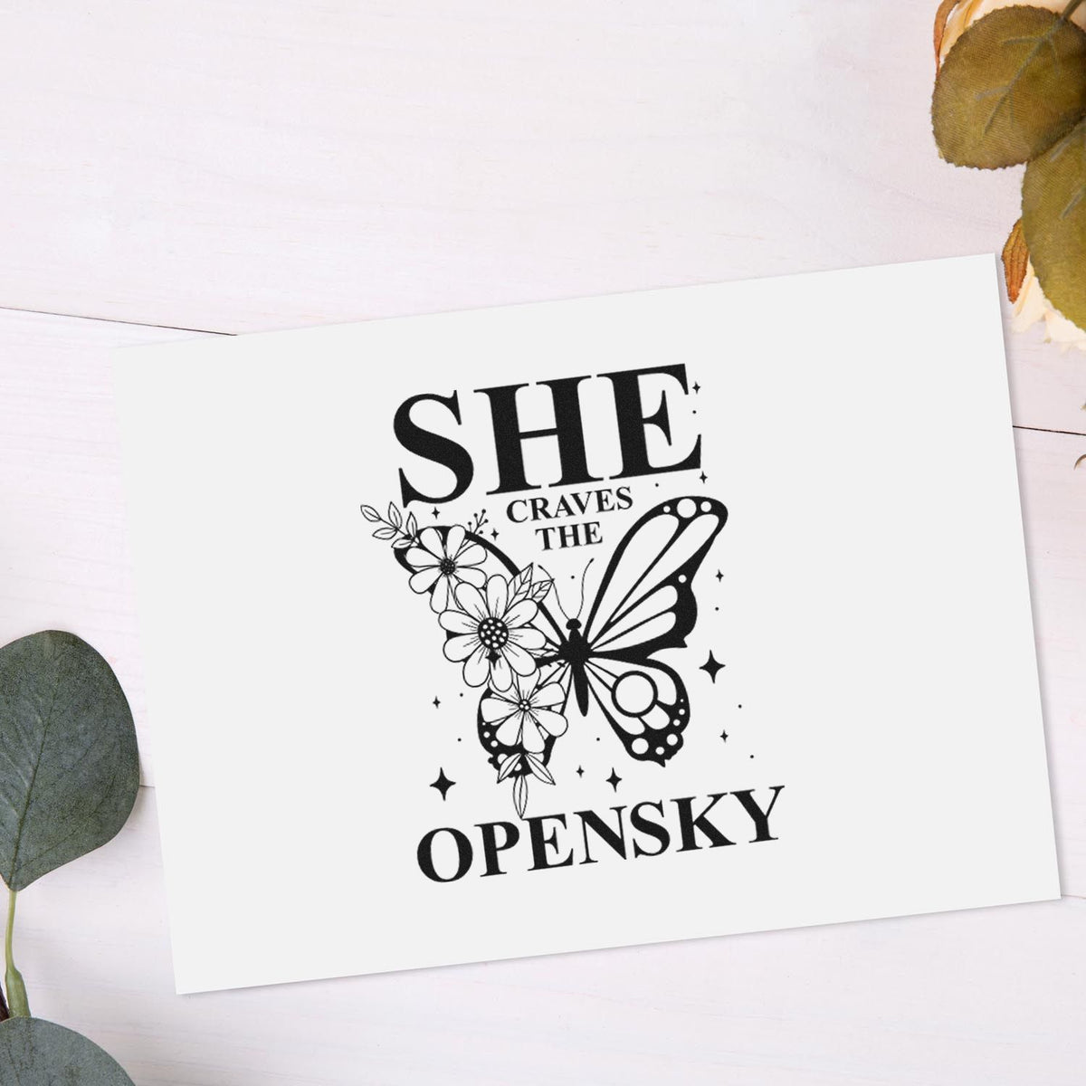 Custom rubber stamp design with butterfly and floral quote, She Craves the Open Sky, for stationery and craft projects.