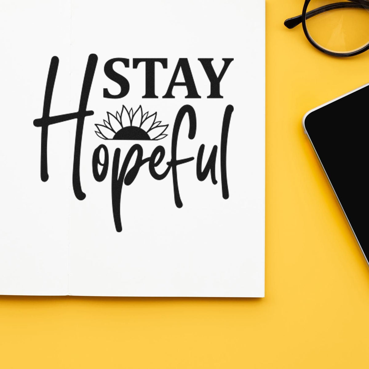 Stay Hopeful rubber stamp design on notebook mockup with sunflower, for inspirational stationery and crafts.