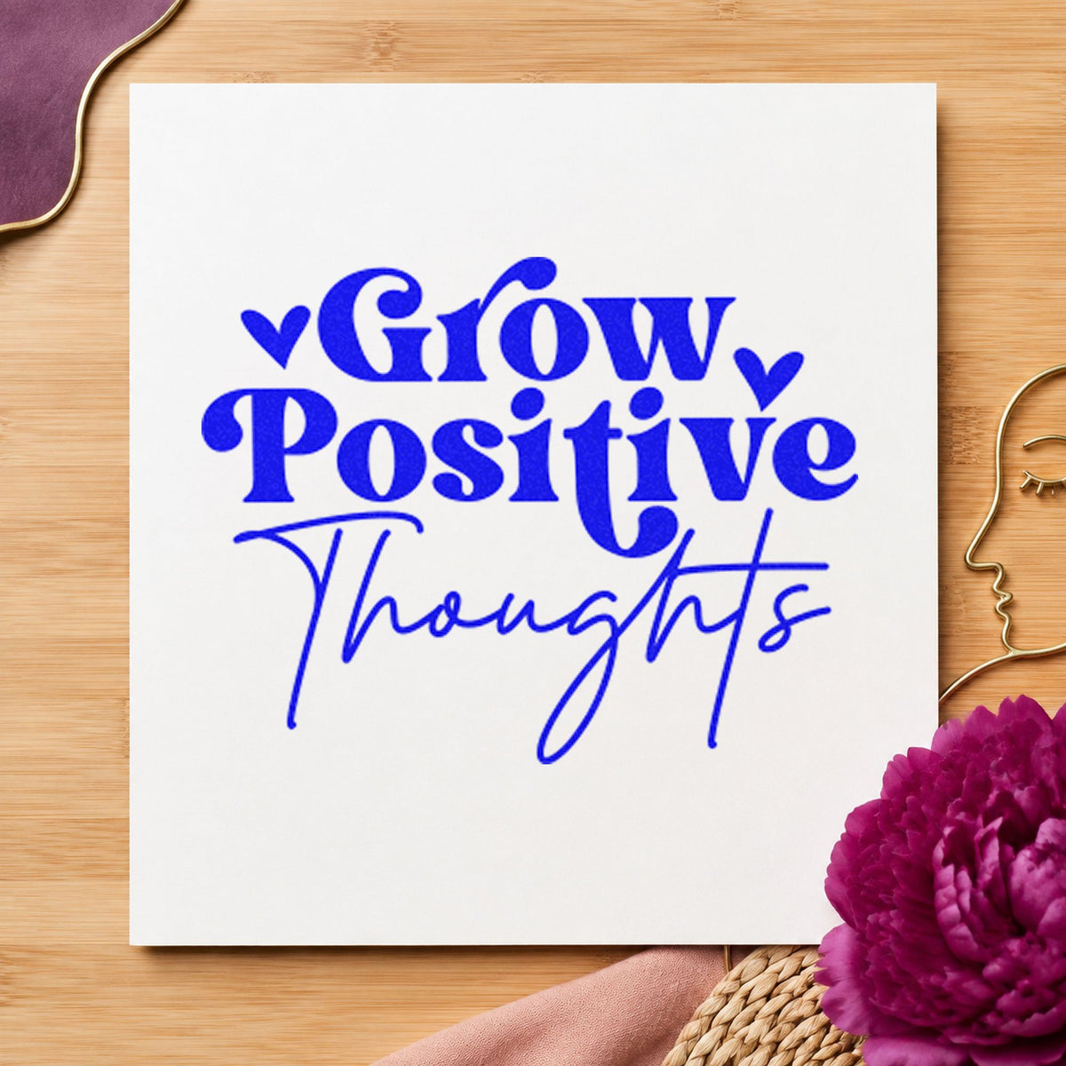 Grow Positive Thoughts Hearts craft stamp imprinted in blue ink on paper, a design suited to framed site shed.