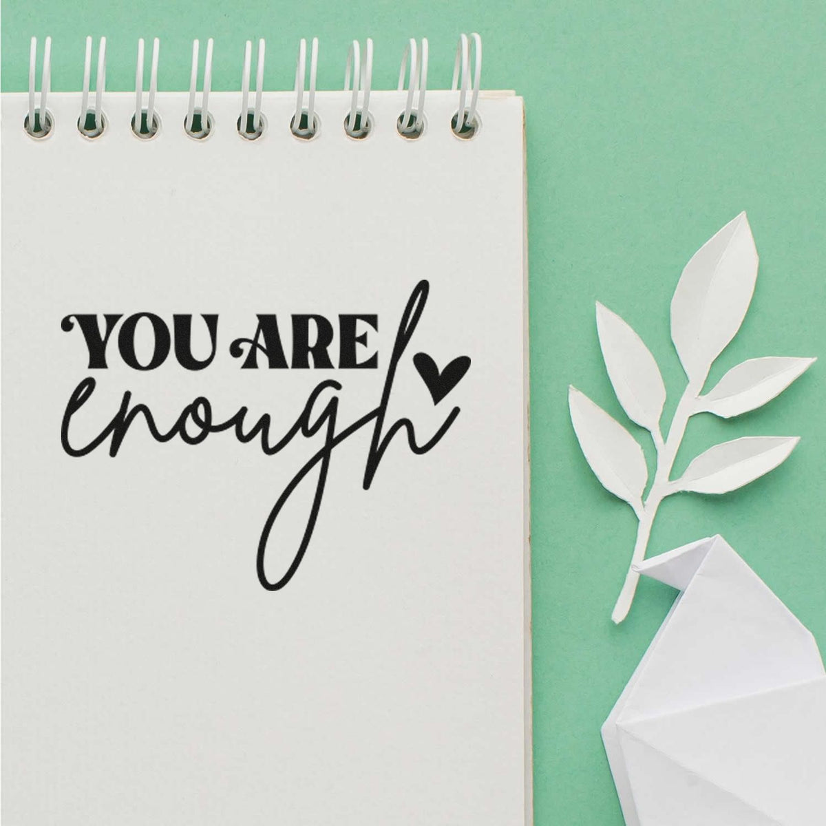 You Are Enough rubber stamp design on a notebook, ideal for uplifting handmade cards, journaling, and craft projects.