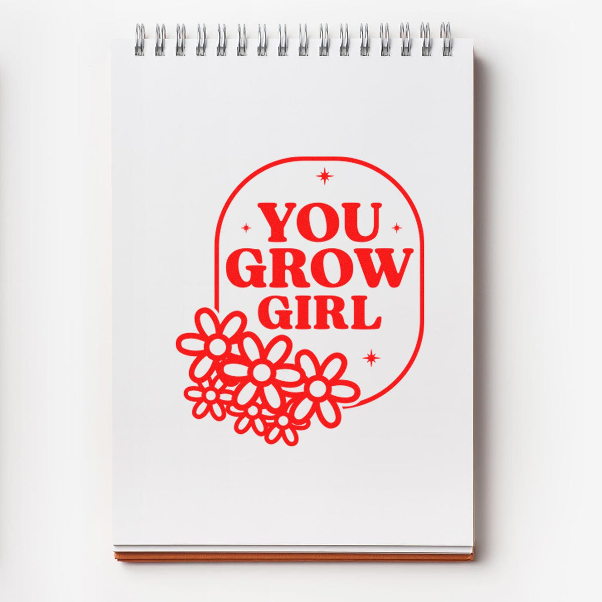 You Grow Girl rubber stamp design with retro floral lettering on a notebook, perfect for inspirational crafts and journaling.