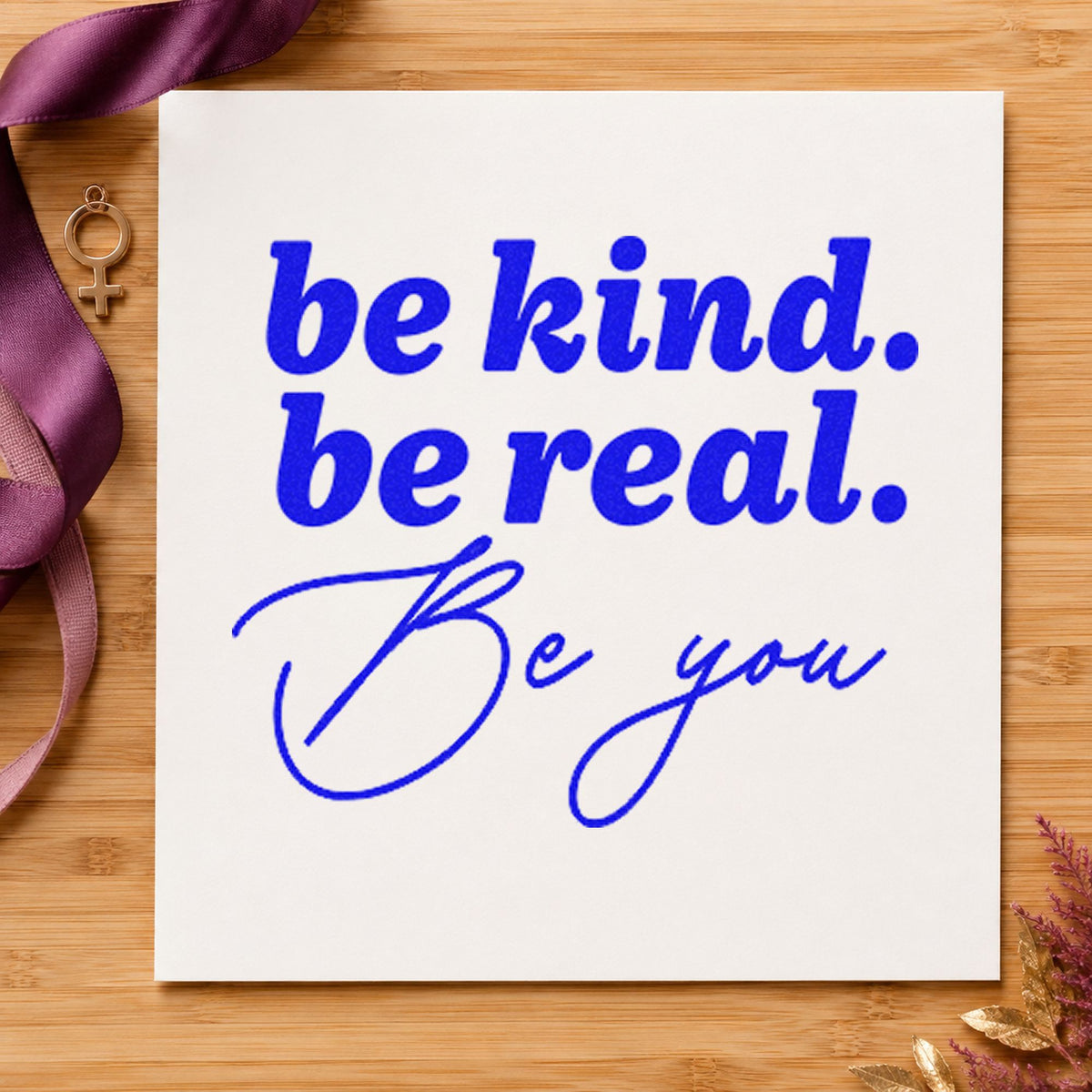 Be Kind Real You craft stamp imprinted in blue ink on paper, a design suited to framed classroom door.