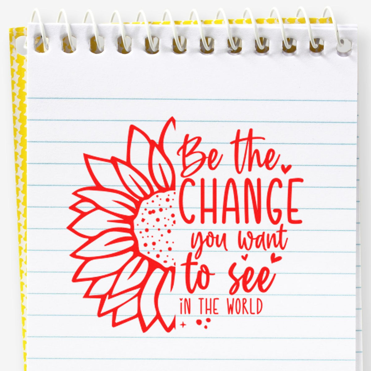 Red sunflower rubber stamp with Be the change you want to see in the world motivational quote on a notebook page.