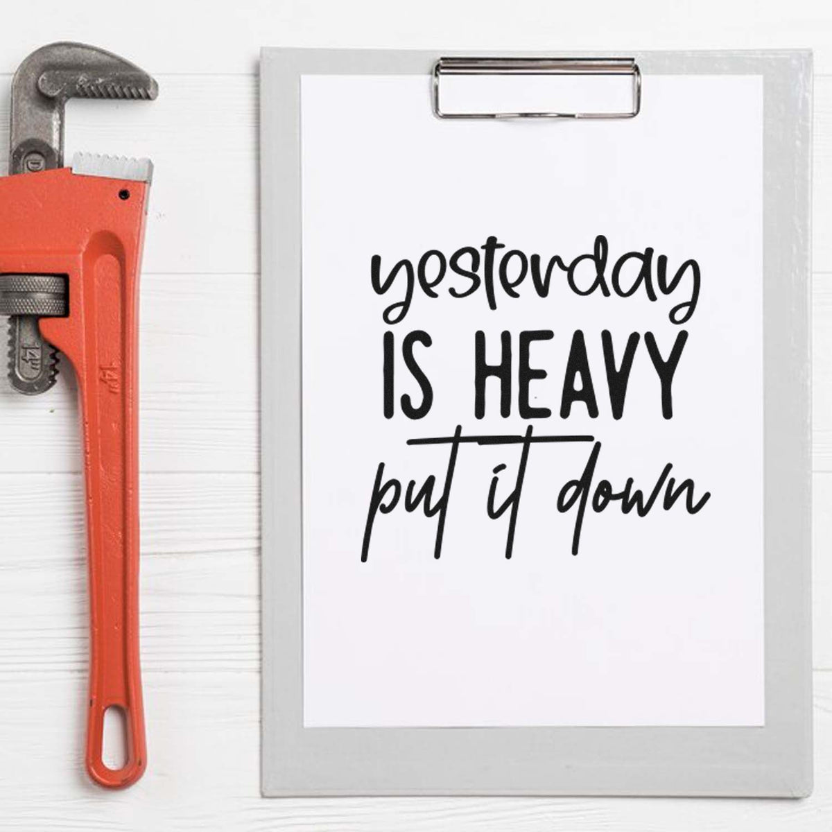 Inspirational rubber stamp quote Yesterday is heavy, put it down on clipboard with wrench, ideal for craft projects.