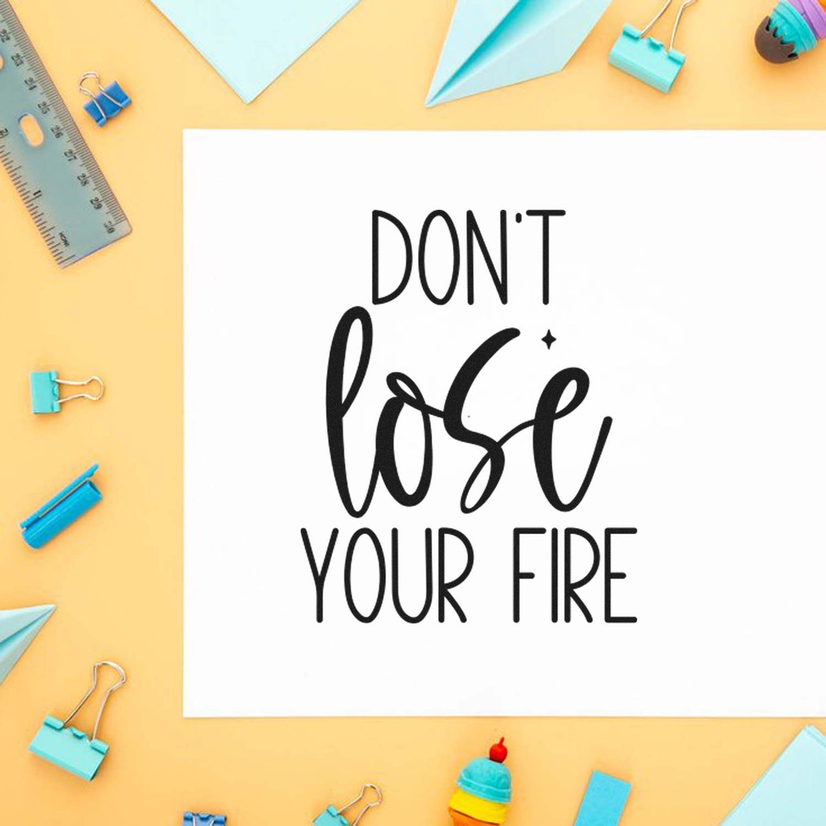 Motivational rubber stamp design reading Dont lose your fire with playful stationery accents and pastel craft theme.