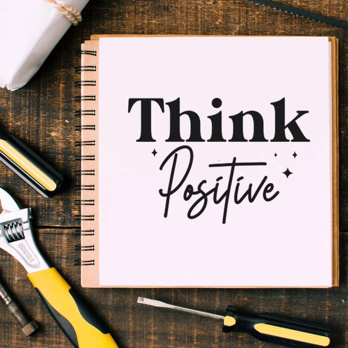 Think Positive rubber stamp design on notebook for motivational journaling, planners, and craft projects.