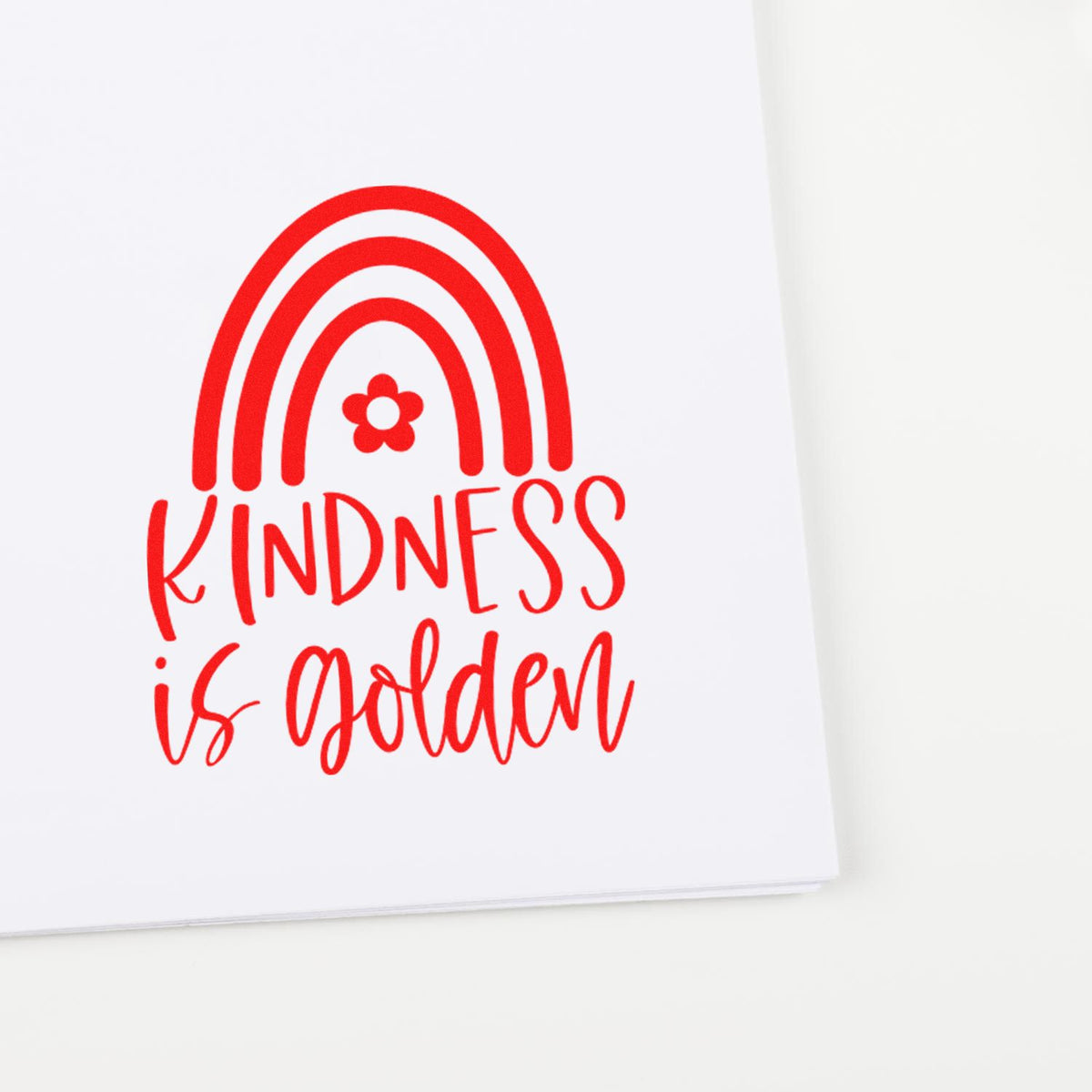Red Kindness is Golden rainbow rubber stamp design with flower, printed on white paper for inspirational crafts.