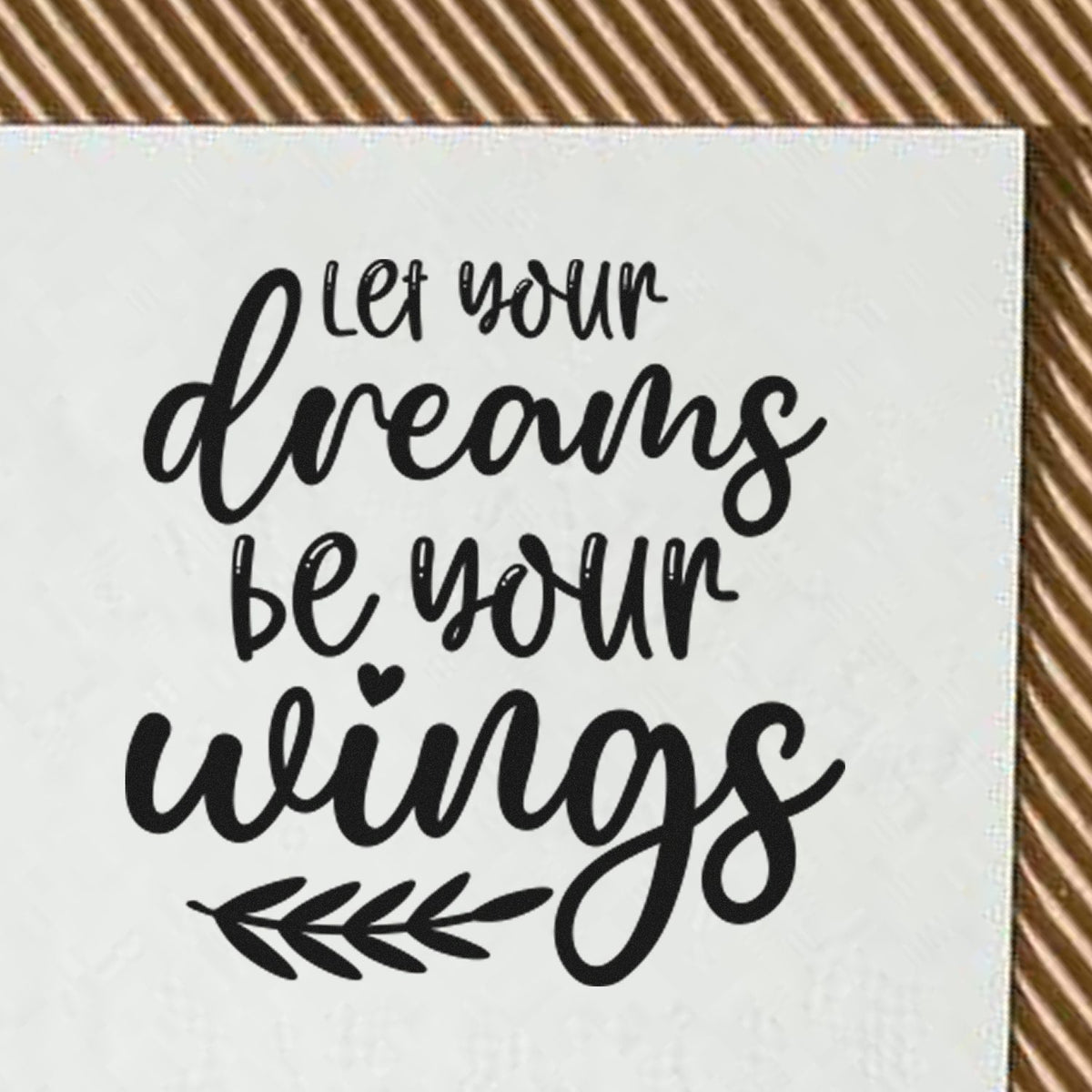 Inspirational rubber stamp design with quote Let your dreams be your wings in script lettering and leaf accent.