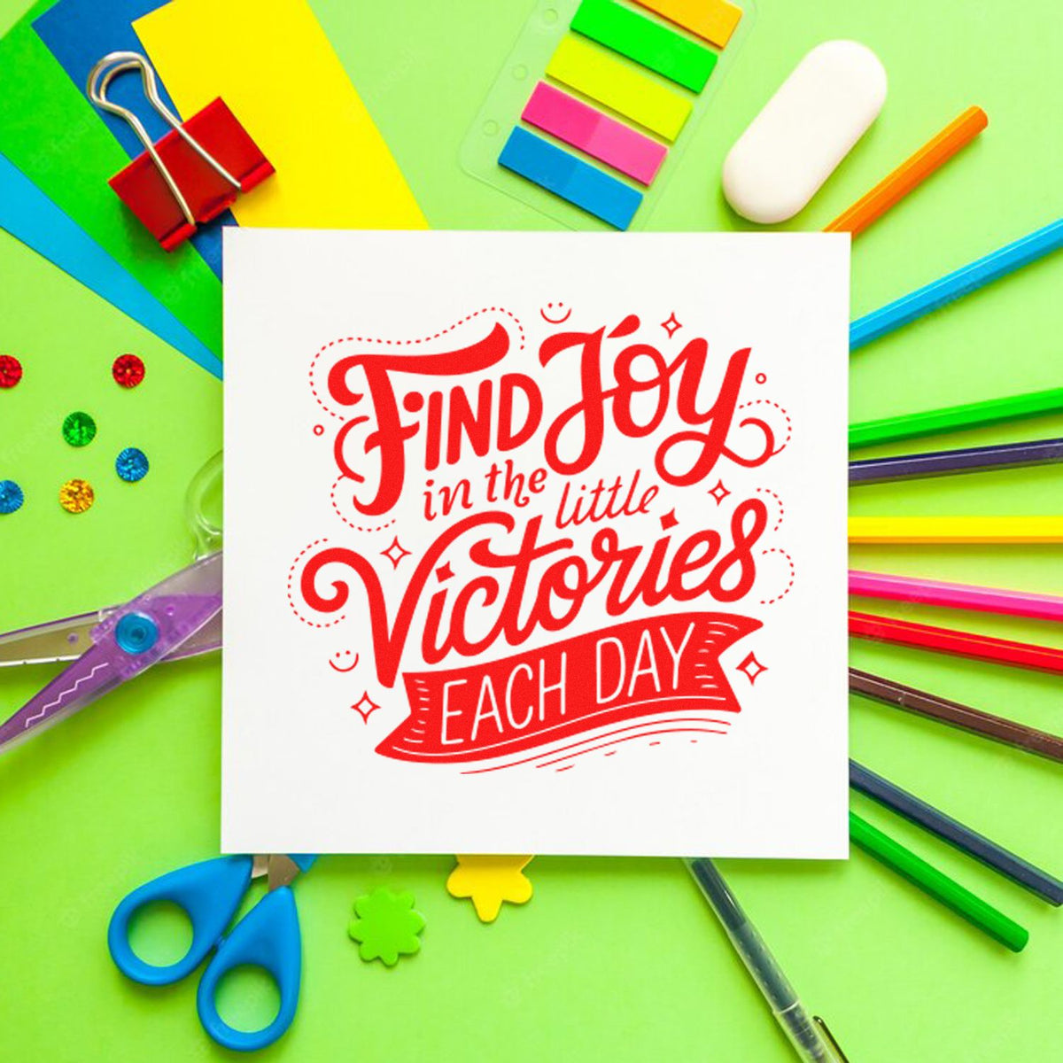 Custom rubber stamp design reading Find Joy in the little Victories each day, styled with colorful stationery and craft supplies.