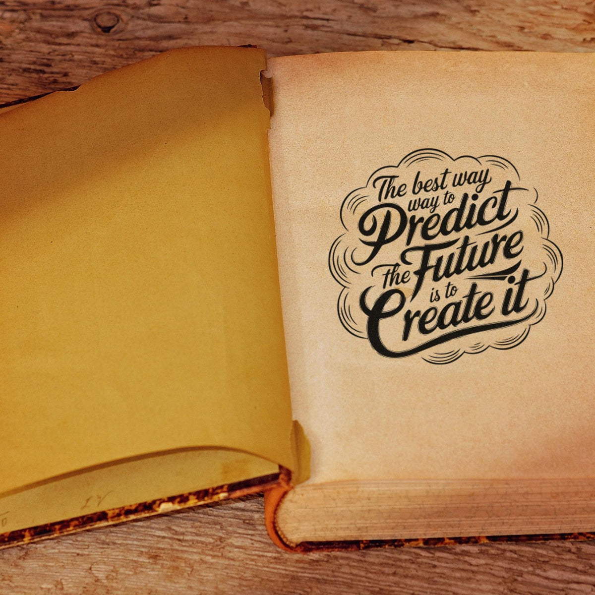 Inspirational rubber stamp quote on open vintage book: The best way to predict the future is to create it.