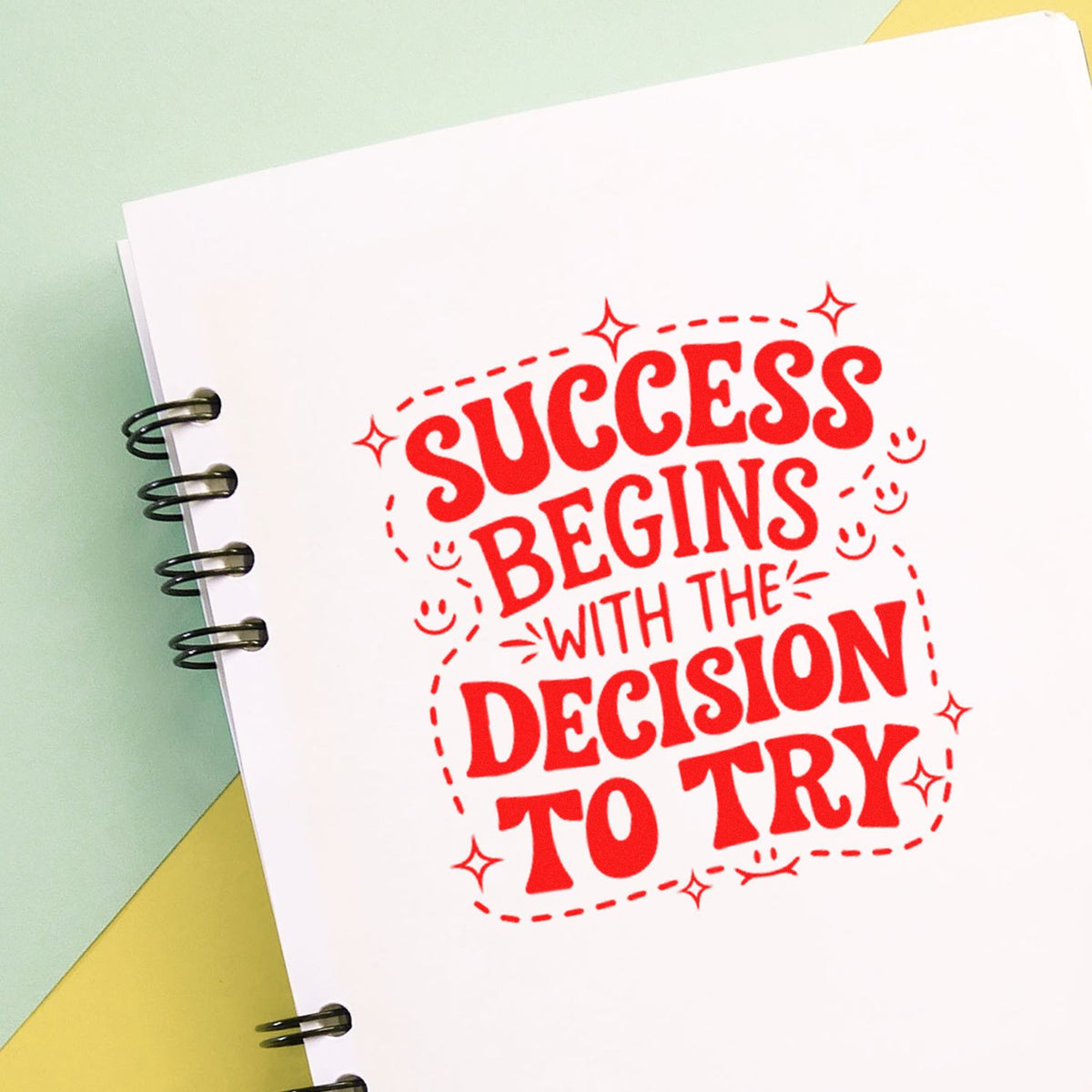 Motivational rubber stamp reading Success begins with the decision to try on a notebook page for planners and journals.