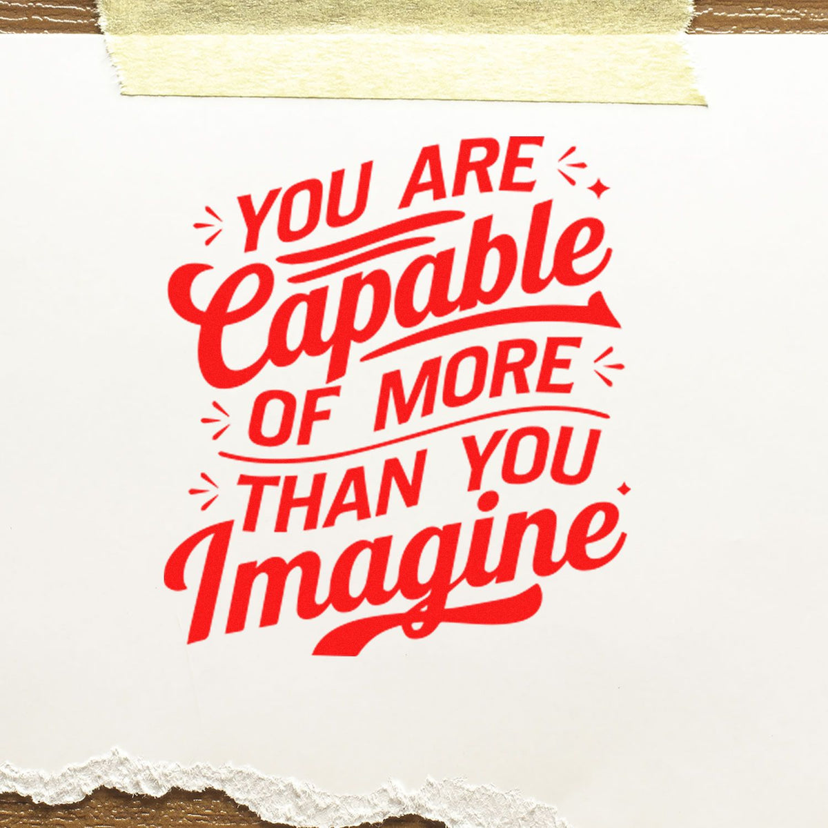 Inspirational rubber stamp design reading You Are Capable of More Than You Imagine in bold red lettering.