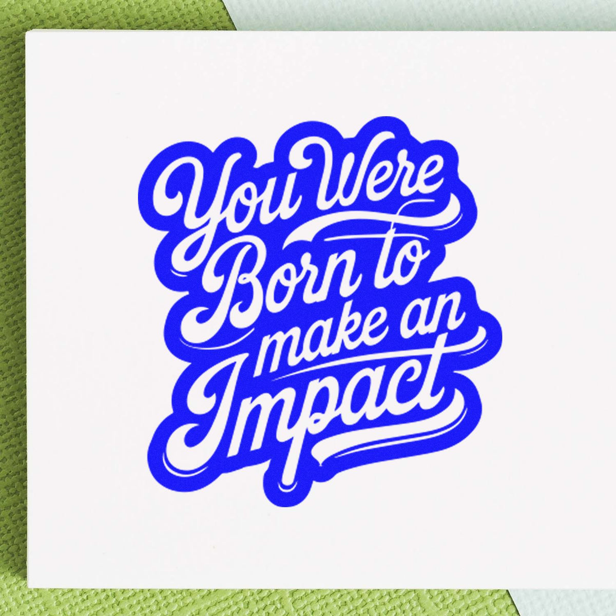 Custom rubber stamp design with blue script quote, You Were Born to Make an Impact, for branding or stationery.