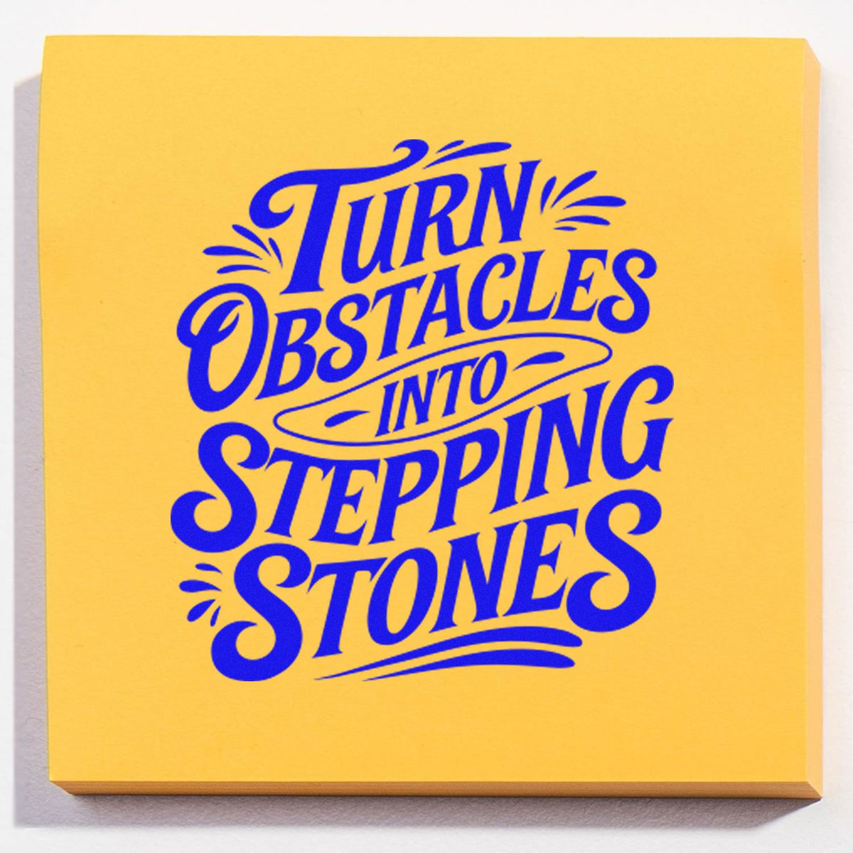 Custom motivational rubber stamp design reading Turn Obstacles Into Stepping Stones in bold blue lettering.