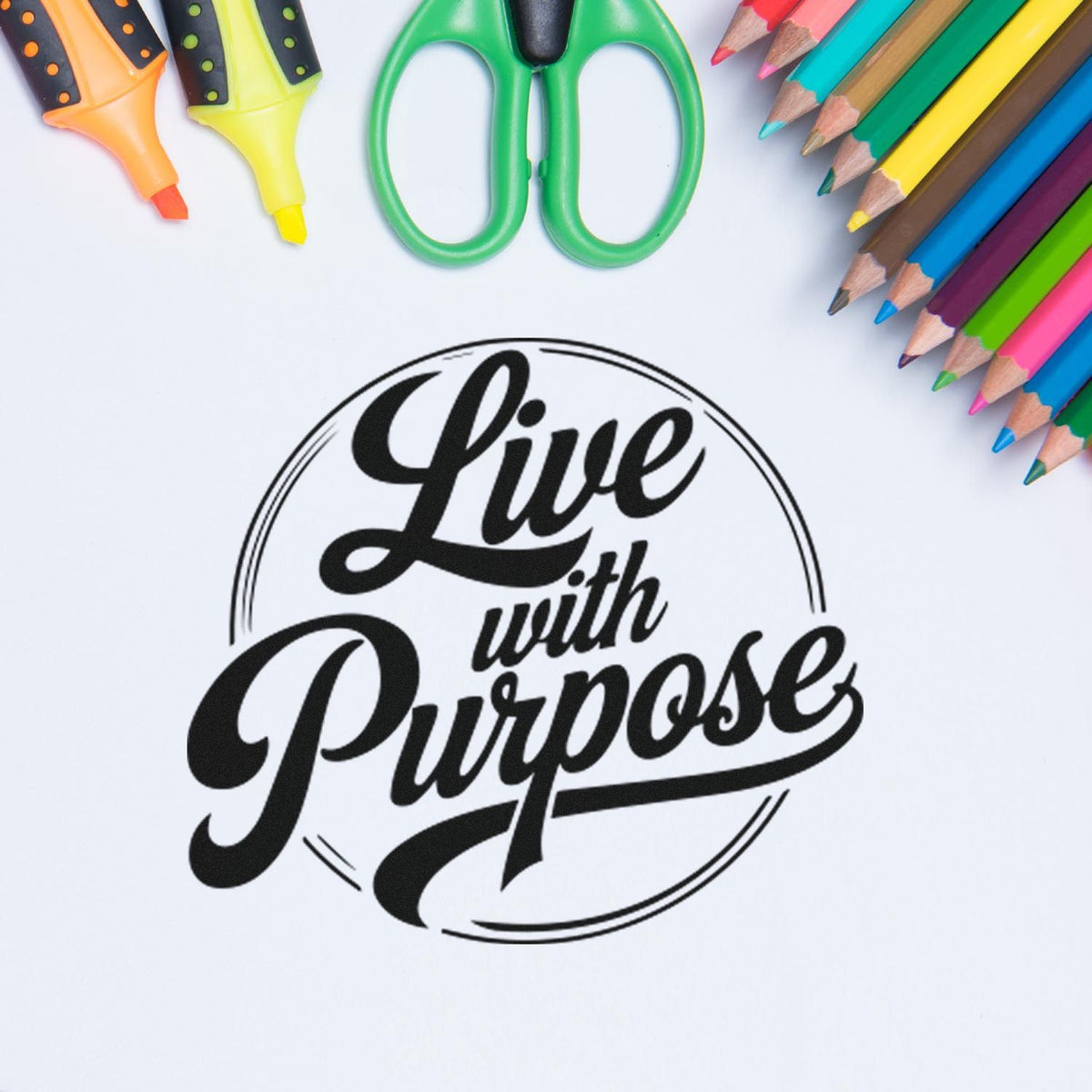 Custom motivational rubber stamp reading "Live with Purpose," framed by colorful pencils and scissors for school crafts.