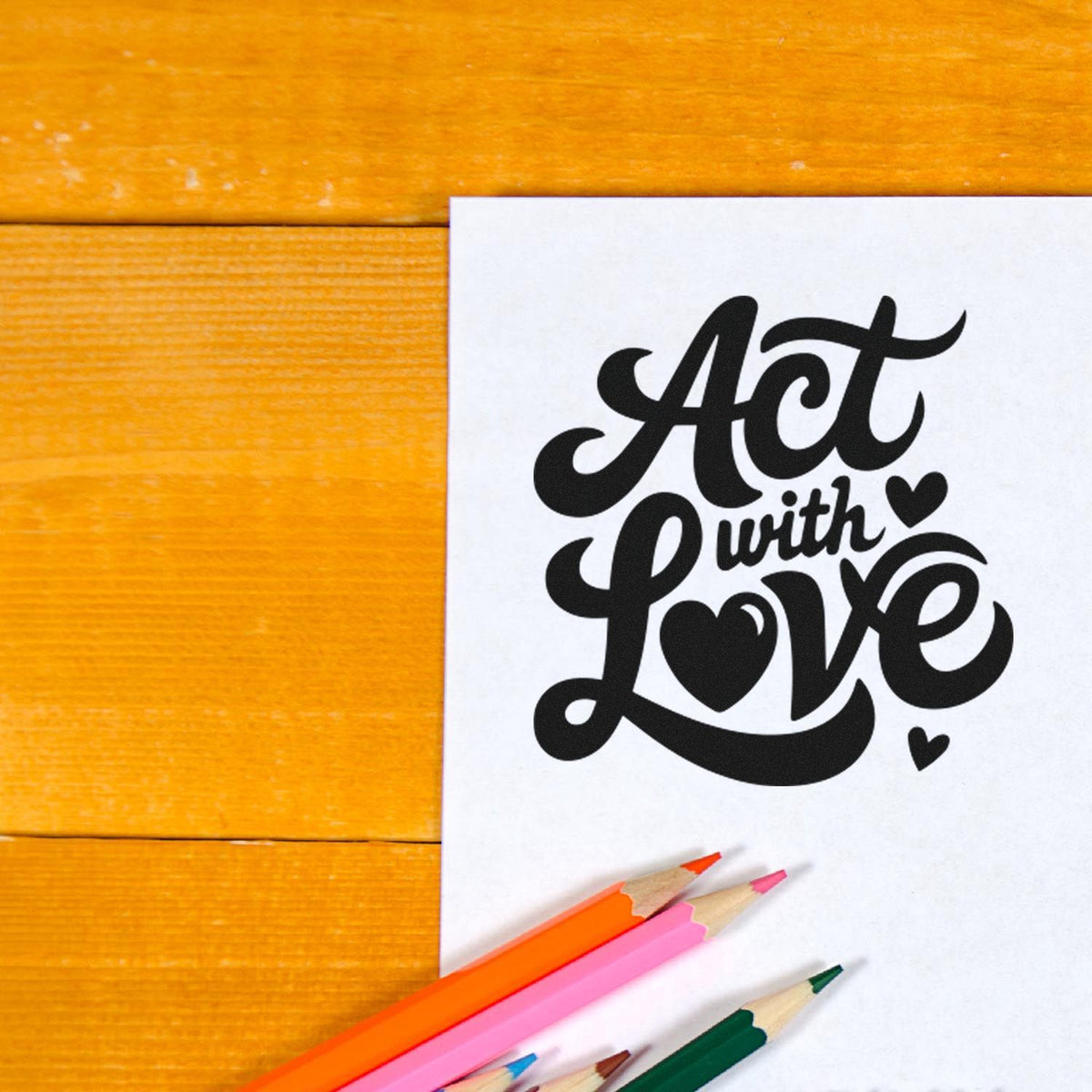 Act with Love rubber stamp design on paper with colored pencils, ideal for handmade cards, crafts, and inspirational projects.