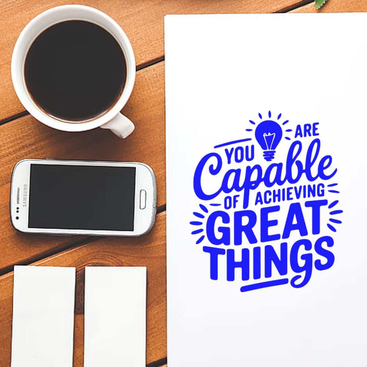 Custom rubber stamp design with motivational quote You are capable of achieving great things in blue on white paper.