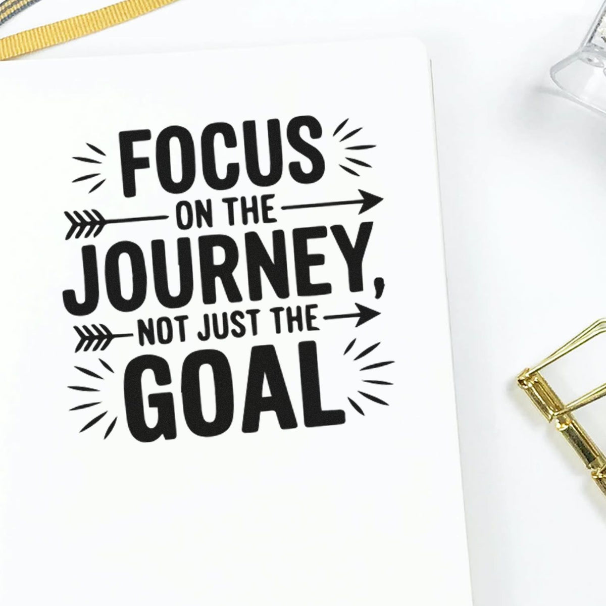 Motivational rubber stamp design reading Focus on the journey, not just the goal on white paper.