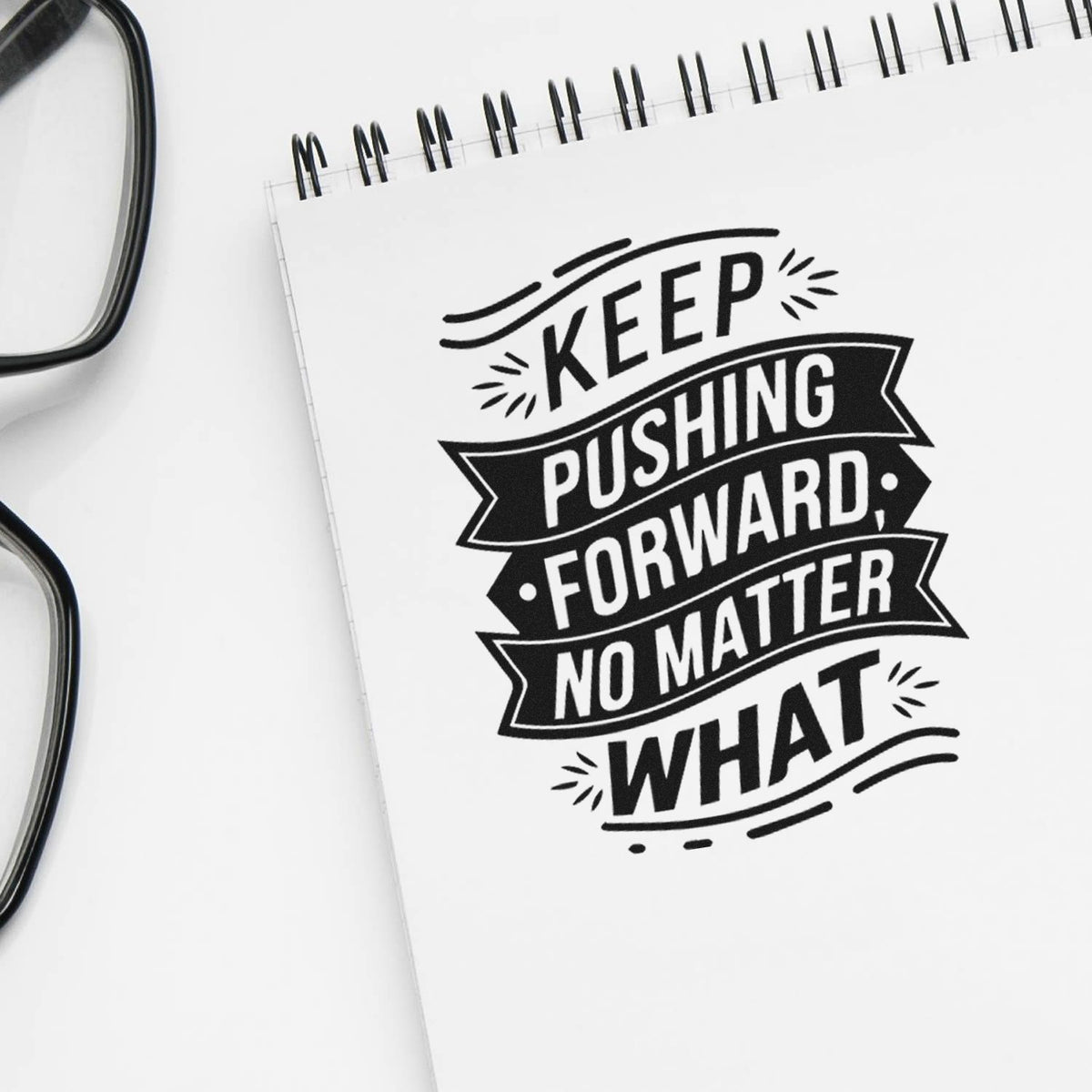 Inspirational rubber stamp design with quote Keep pushing forward no matter what on a notebook, ideal for motivation-themed stamping.