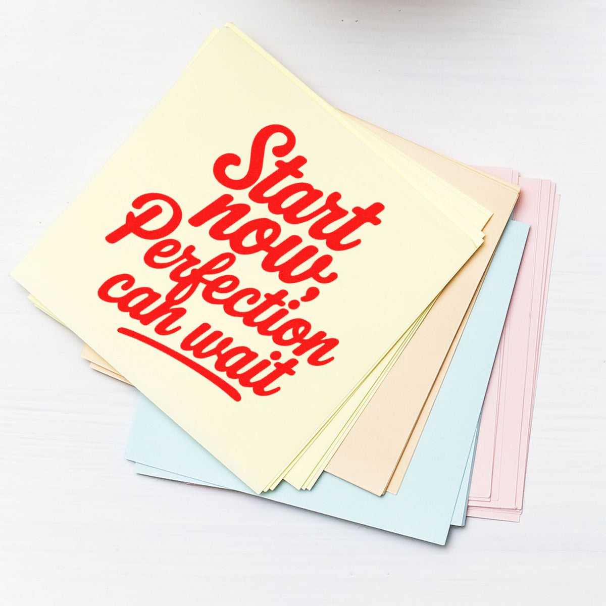 Motivational rubber stamp reading Start now, perfection can wait on pastel stationery paper for planners and crafts