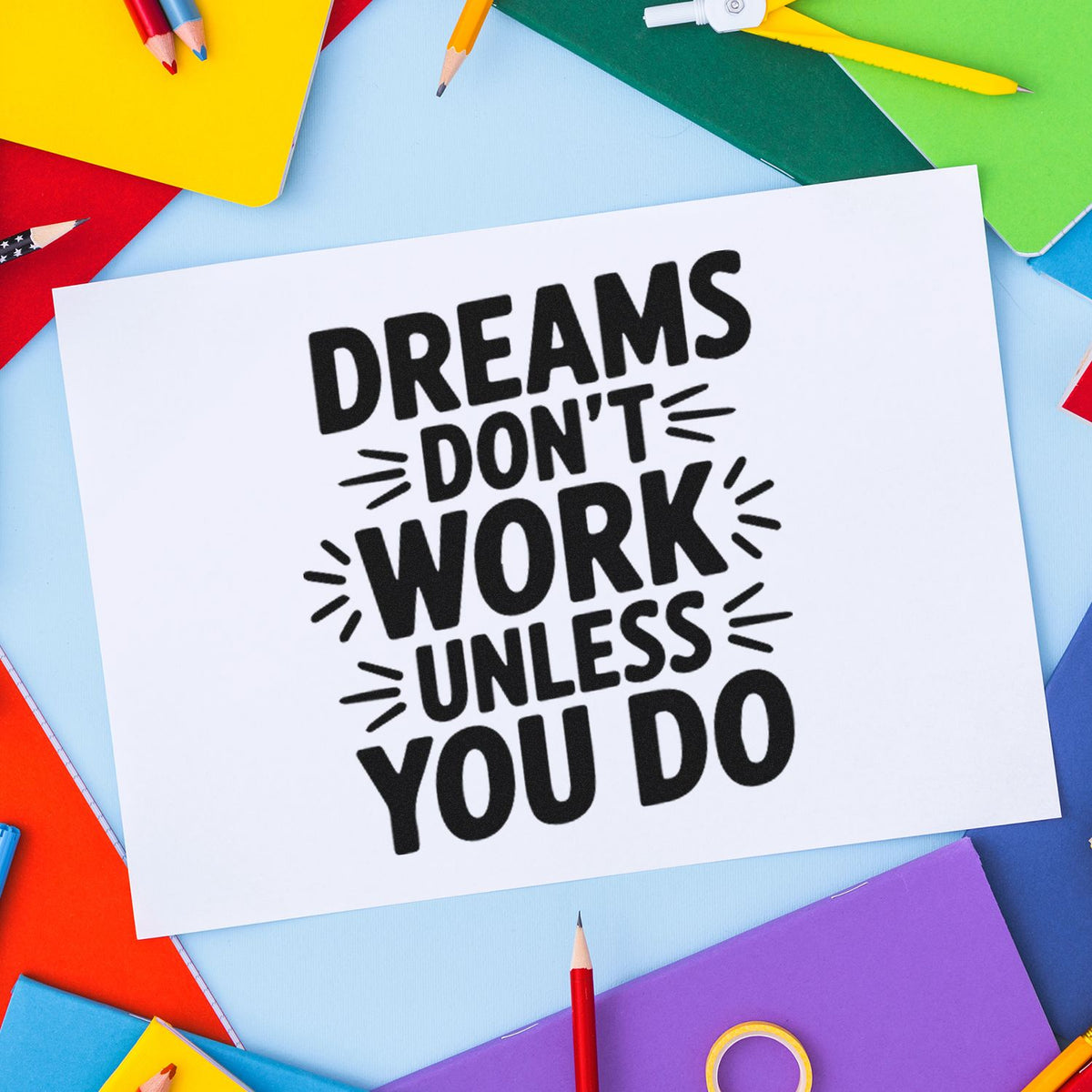 Motivational rubber stamp design reading Dreams dont work unless you do on white paper with colorful school supplies.