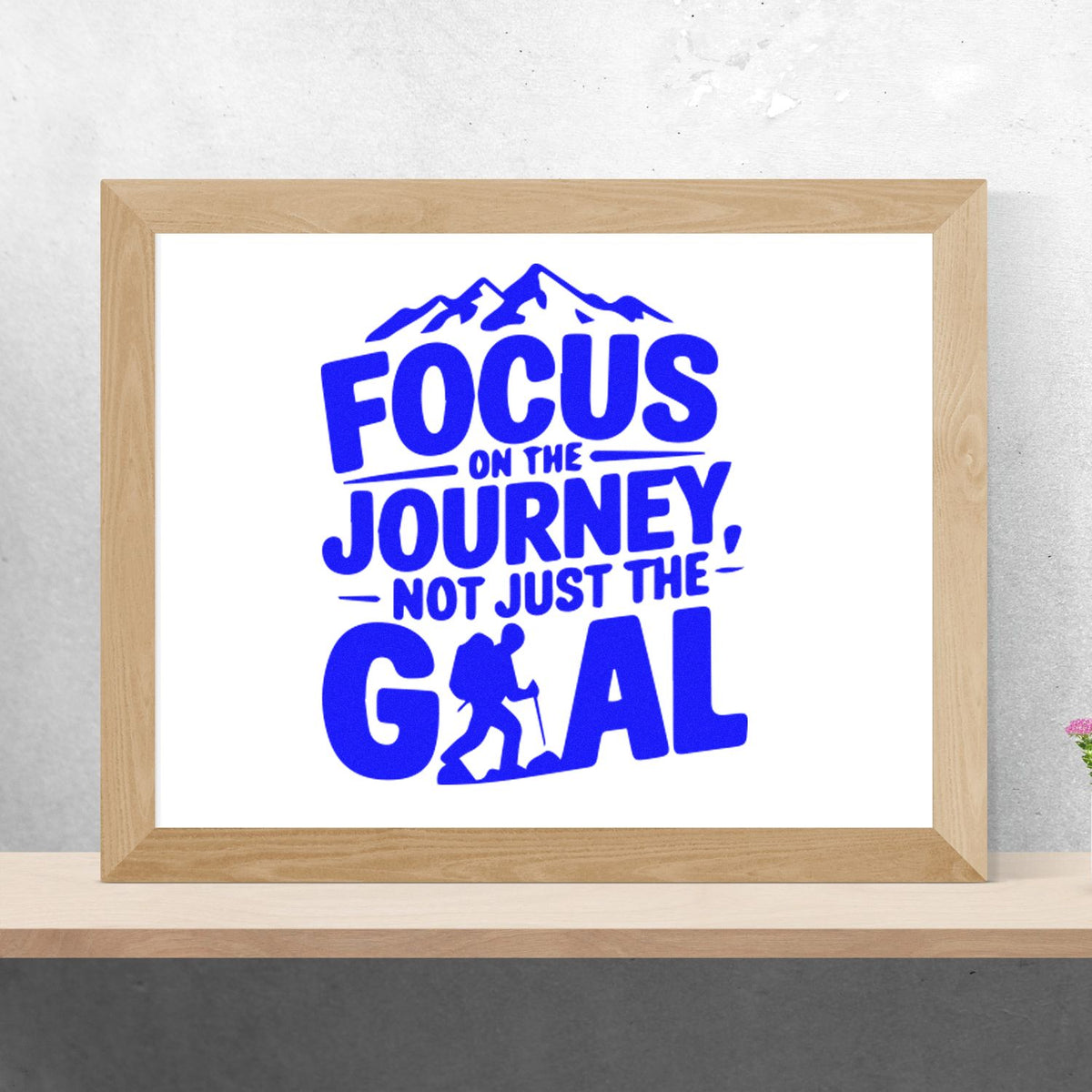 Blue motivational hiking rubber stamp design reading Focus on the journey, not just the goal with mountain and hiker graphic.