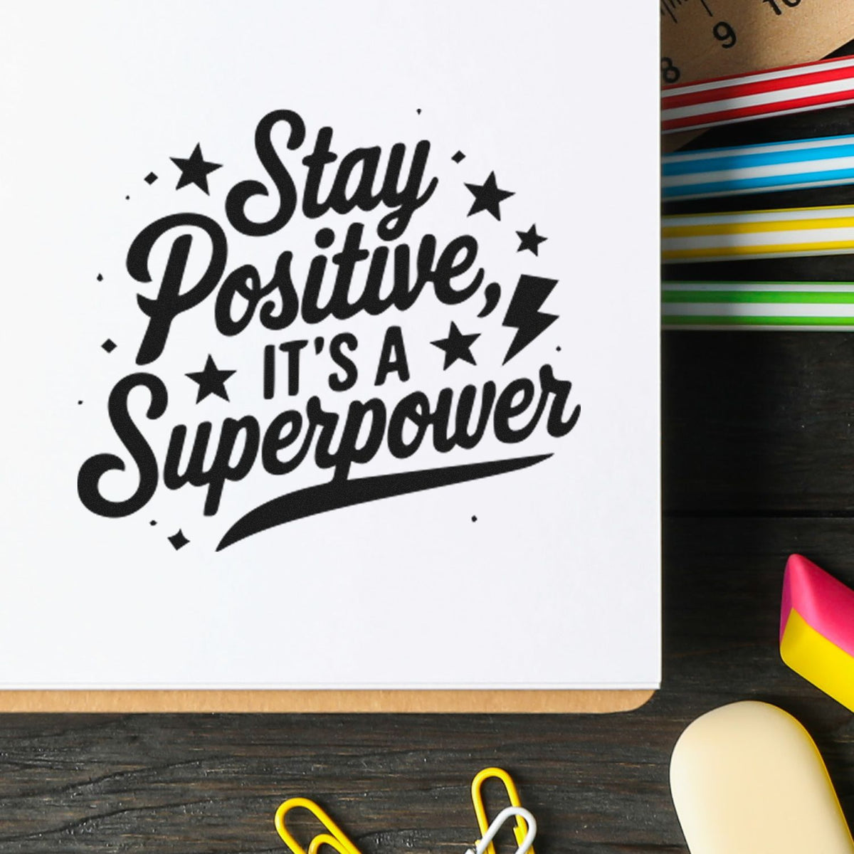 Motivational rubber stamp design reading Stay Positive, Its a Superpower on notebook paper with stars and lightning accents.
