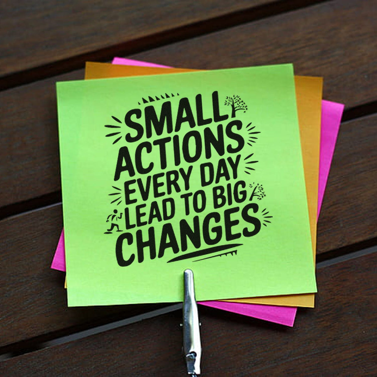 Custom rubber stamp imprint on colorful sticky notes with motivational message: Small actions every day lead to big changes.
