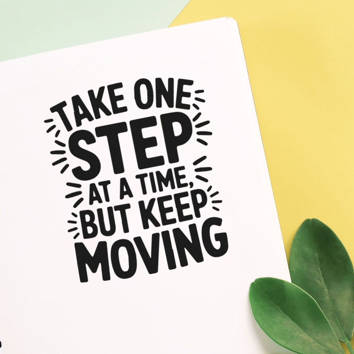 Motivational rubber stamp quote reading Take one step at a time, but keep moving on a greeting card.