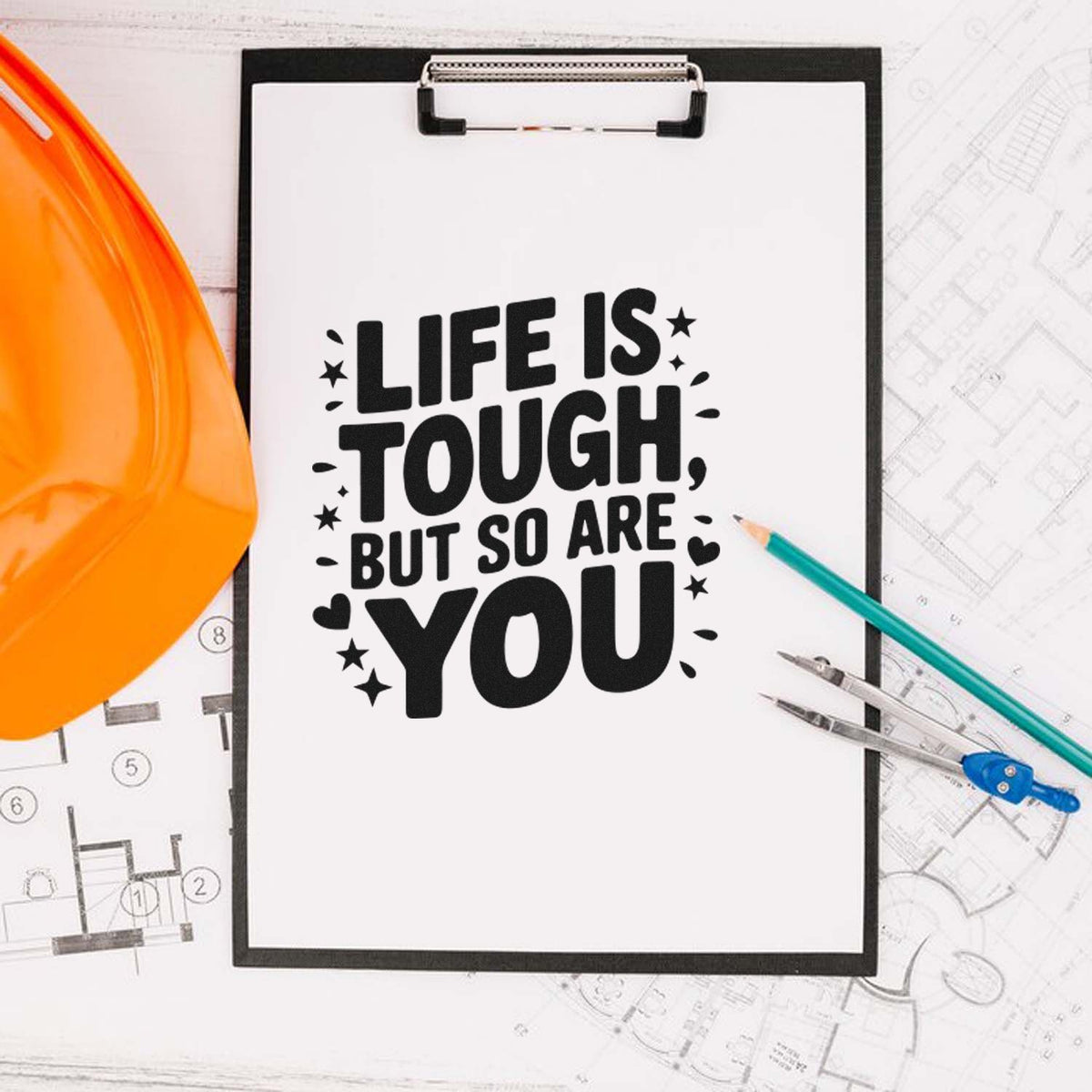 Motivational rubber stamp design reading Life is tough, but so are you with hard hat, clipboard, and construction blueprints.
