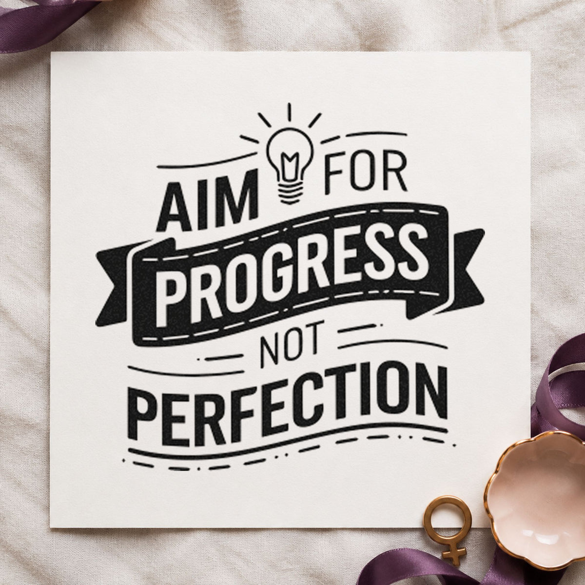 Aim Progress Not Perfection rubber stamp printed in black ink, ready for ribbon bulb cards and similar paper crafts.