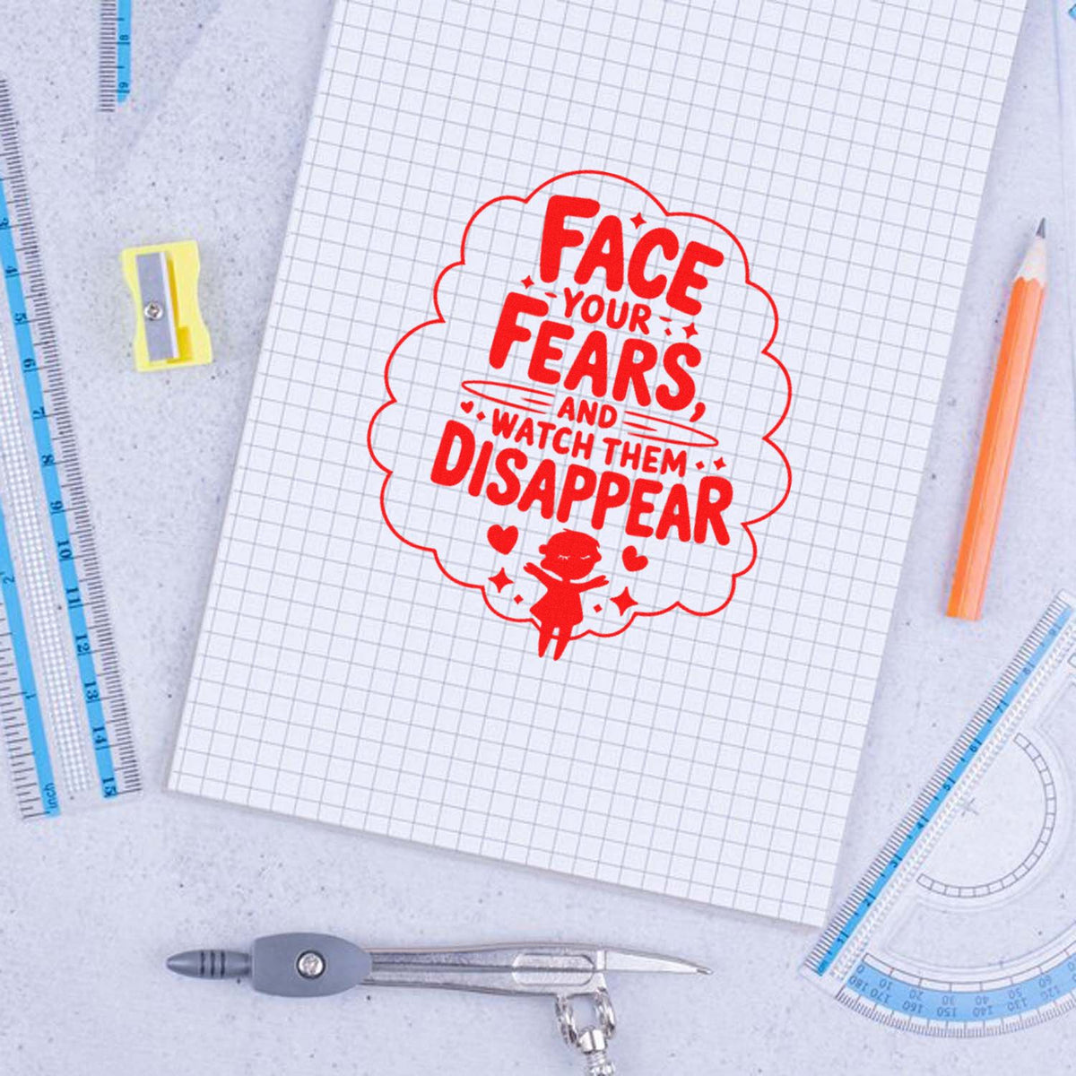 Red custom rubber stamp design on graph paper reading Face your fears, and watch them disappear with school supplies.