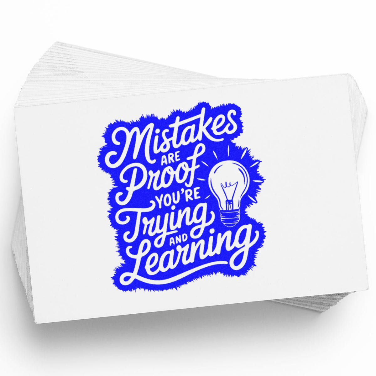 Motivational rubber stamp with quote Mistakes are proof youre trying and learning and a lightbulb graphic in blue.
