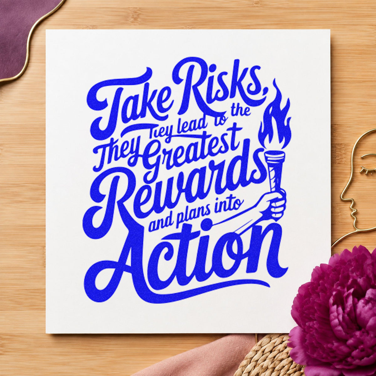Take Risks Rewards Action craft stamp imprinted in blue ink on paper, a design suited to framed start tent.