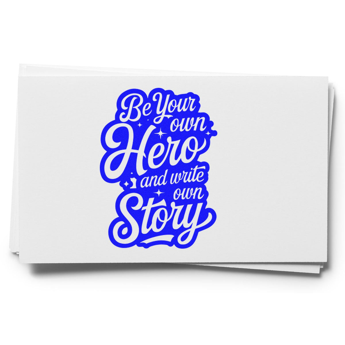 Blue inspirational rubber stamp design with Be Your Own Hero and Write Your Own Story lettering on white paper.