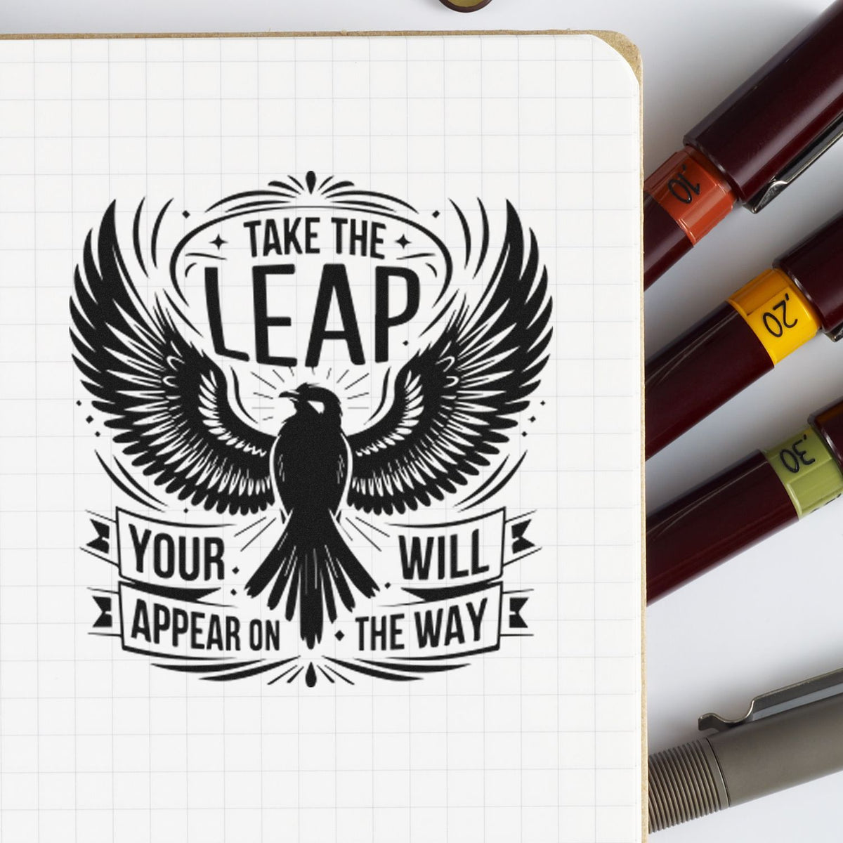 Inspirational custom rubber stamp with eagle and Take the Leap quote on notebook page.