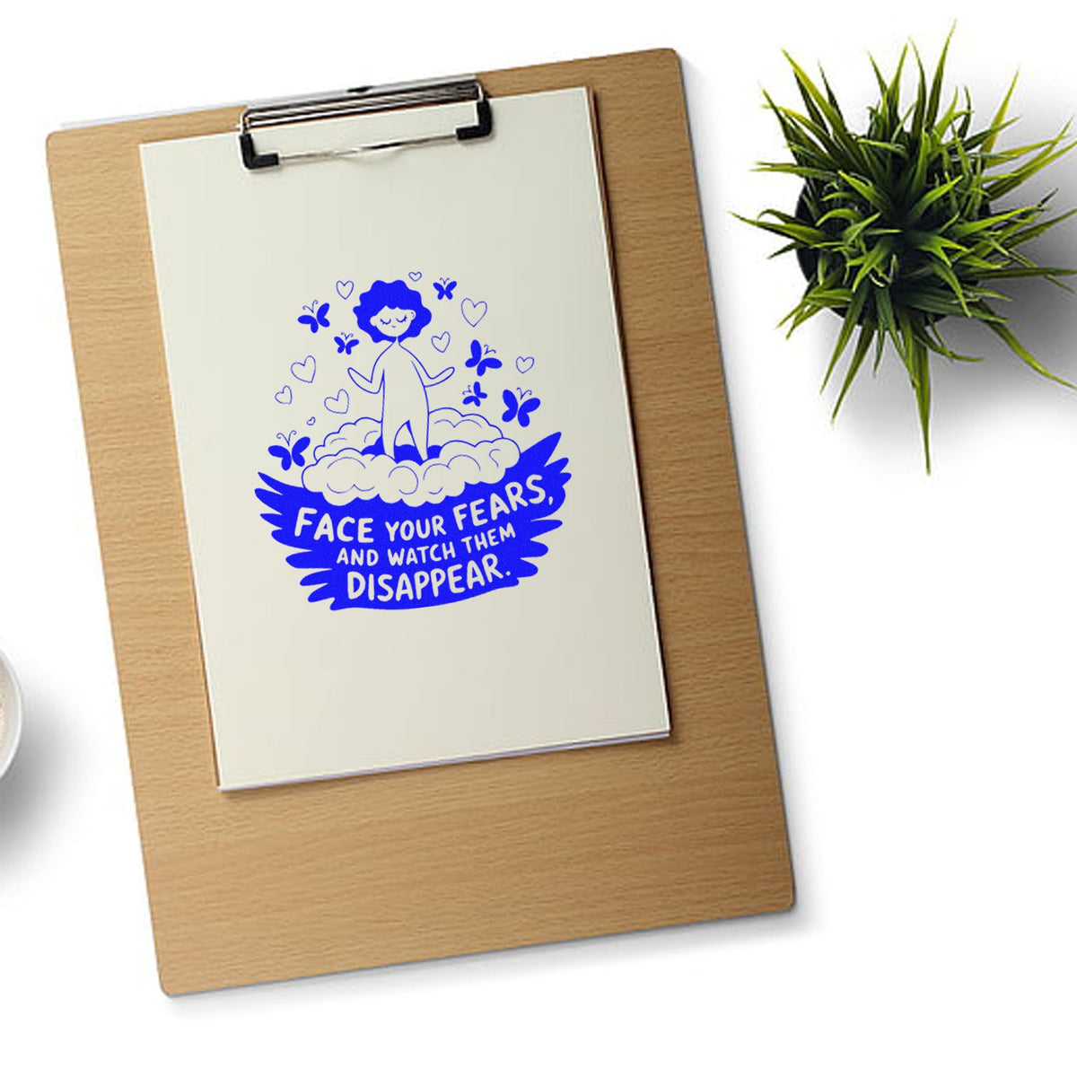 Blue motivational rubber stamp design on clipboard reading Face your fears and watch them disappear for inspiring stationery.