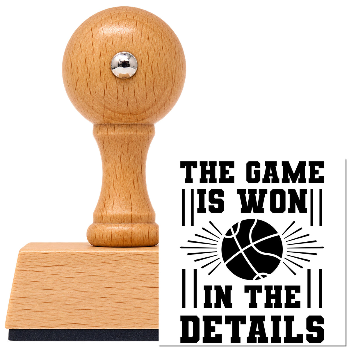 The Game Is Won In The Details Vintage Pro rubber stamp in European beech wood with a round knob handle, shown beside its black imprint.