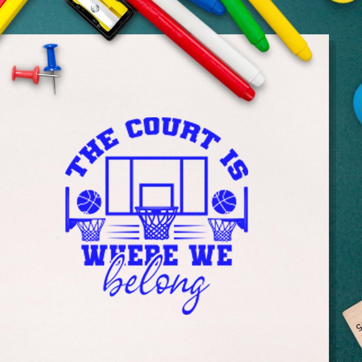 Basketball rubber stamp reading The Court Is Where We Belong for school sports, team spirit, and classroom awards.