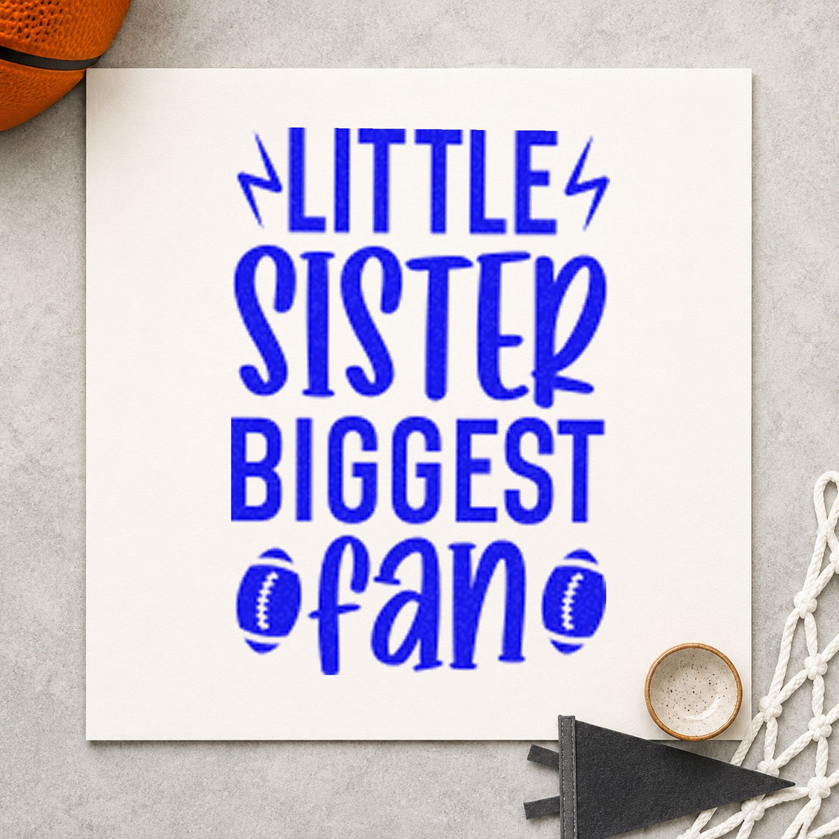 Little Sister Biggest Fan craft stamp imprinted in blue ink on paper, a design suited to framed bedroom shelf.