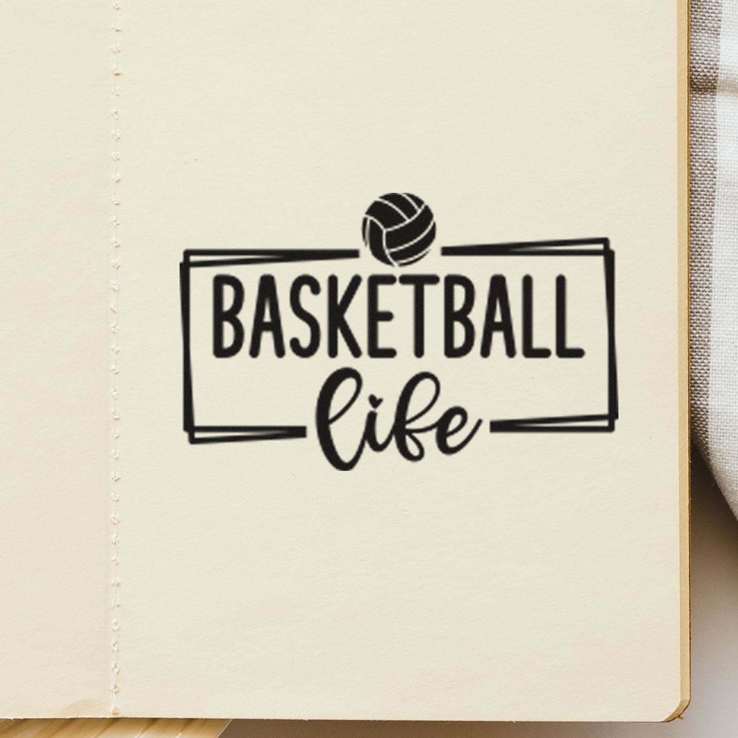 Basketball Life rubber stamp impression with basketball icon on notebook page for sports-themed crafting and journaling